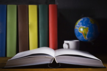 Open book and colorful books