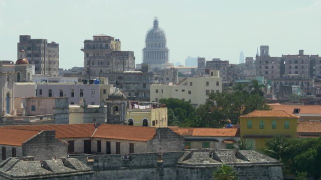 A high angle dolly establishing shot of the capitol dome in the old town section of Havana, Cuba. Shot in 5K.  	