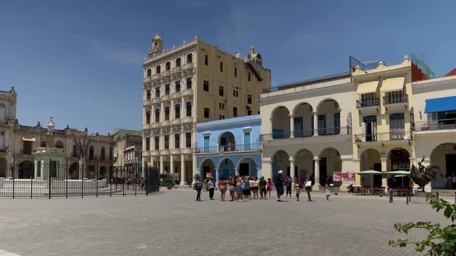 HAVANA, CUBA - Circa July, 2017 - A daytime exterior establishing shot of tourists visiting Havana's Old Town Square (Plaza Vieja). Shot in 5K.  	
