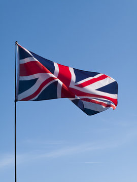 United Kingdom Union Jack Flag against a clear blue sky