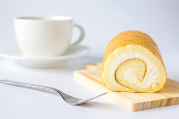 Swiss roll and coffee on white background.