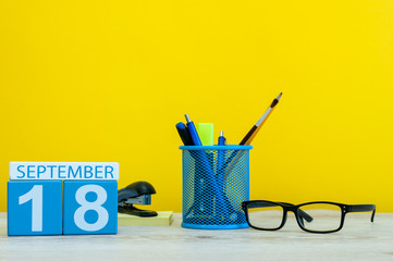 18th September. Image of september 18, calendar on yellow background with office supplies. Fall, autumn time