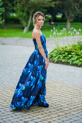 Beautiful young blonde woman wearing in blue dress