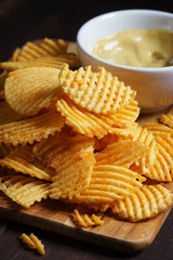 Crispy potato chips with ripple in white bowl