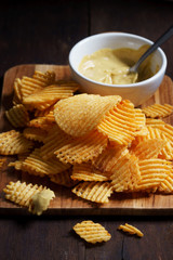 Crispy potato chips with ripple in white bowl