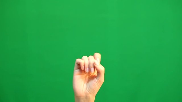 Hand gestures. Touchscreen. Female hand showing multitouch gestures in green screen