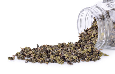 Tea leaves in a glass jar isolated from a white background.