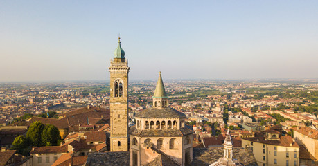 Naklejka premium Bergamo, old city, drone aerial view of the Basilica of Santa Maria Maggiore. On the background the Padana plain
