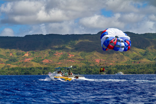 Parasailing tourists enjoy the warm waters of Guam