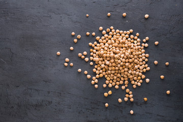 Pile of dried chickpeas on a dark surface