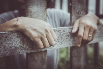 prisoner behind wooden bars : social issue