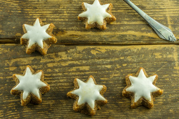 Christmas decoration with cinnamon stars on a rustic board