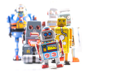 Group of Retro Tin Robots on a white background with copy space
