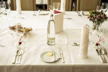 Table setup at marriage waiting for guests with dishes water flowers