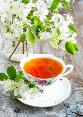 Cup of tea with apple blossom