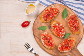 italian appetizer called bruschetta with fresh tomatoes and bread