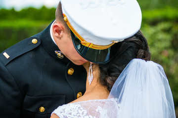 wedding military groom holding bride closeup outside
