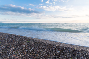 Fototapeta na wymiar Sea surf on a stony beach.