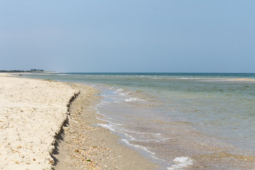 An empty sea sandy beach on beautiful summer day with blue sky