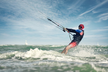 A kite surfer rides the waves