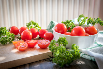 Cherry tomatoes in a plate on a wooden table in vintage style
