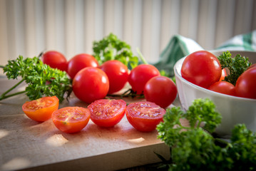 Cherry tomatoes in a plate on a wooden table in vintage style