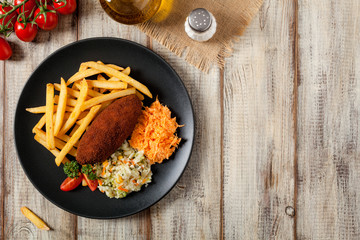 Chicken Kiev (de Volaille chop) with french fries and salads.