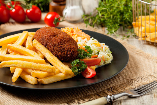 Chicken Kiev (de Volaille chop) with french fries and salads.