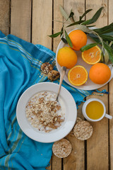 Healthy breakfast, fruit, corn flakes, milk and orange juice on the wooden table