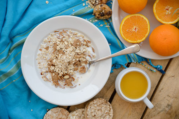Healthy breakfast, fruit, corn flakes, milk and orange juice on the wooden table