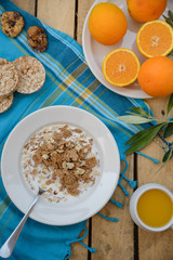 Healthy breakfast, fruit, corn flakes, milk and orange juice on the wooden table