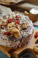 Homemade vegetarian pie with dried fruits on a blue background