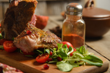 cold boiled pork with tomatoes on the wooden table