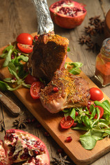 cold boiled pork with tomatoes on the wooden table