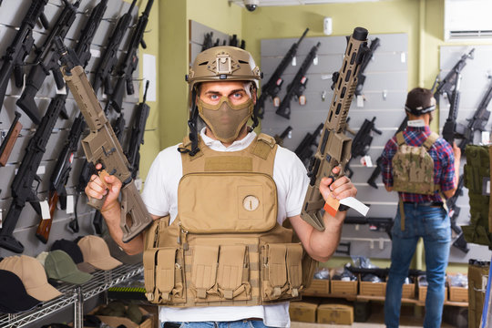 men in army uniform with gun in military market