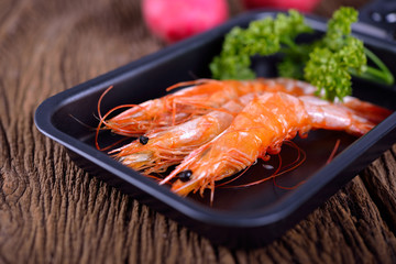 sweet Shrimps stretch boiled in pan on wooden background