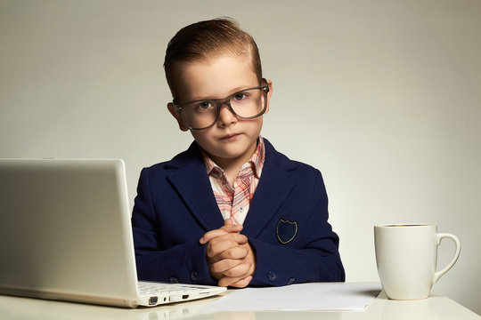 Young business boy with computer.funny child