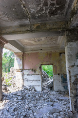 Obraz premium The old abandoned overgrown school building