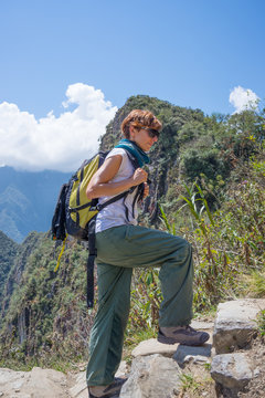 Backpacker exploring the steep Inca Trail of Machu Picchu, the most visited travel destination in Peru. Summer adventures in South America.