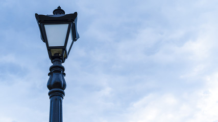 Fototapeta na wymiar Street lamp against the blue sky