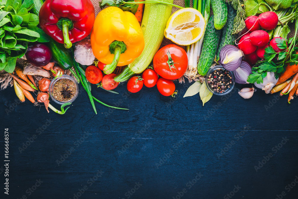 Wall mural frame of organic food. fresh raw vegetables and spices. on a wooden chalkboard.