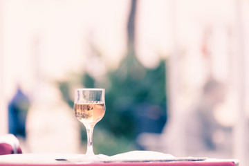 Obraz na płótnie Canvas Glass of wine at the street cafe table