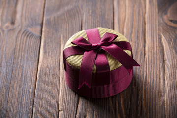 Gift box with bow Ring jewelry for girl Wooden vintage background oak
