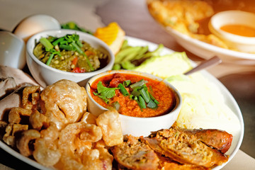 Thai food - Northern style red and green chilli dips with  northern thai spicy sausage (sai oua), streaky pork with crispy crackling and  vegetables