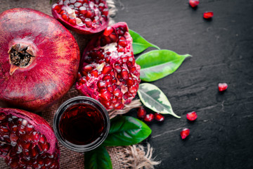 Fresh pomegranate on a dark Wooden surface. Top view.