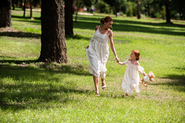 Fototapeta premium mother and daughter walking at park