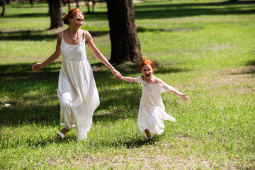 mother and daughter walking at park