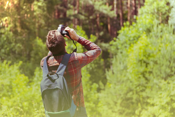 A young man takes photos of nature. Summer-Autumn.