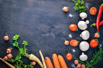 Big set organic food. Fresh raw vegetables. On a black chalkboard.