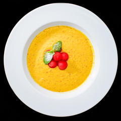 summer delicious fresh smoothie made with apricot and mango in white plate. Beautifully decorated dish, dark background, top view